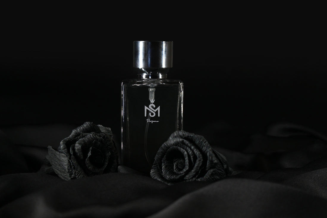 a bottle of perfume sitting on top of a bed