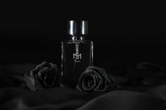 a bottle of perfume sitting on top of a bed