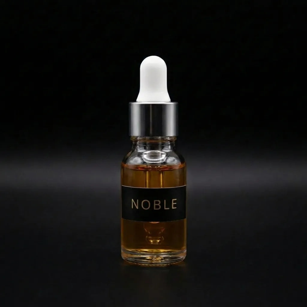 Aramystic Noble 3ml perfume oil in a glass dropper bottle with amber oil on a black background